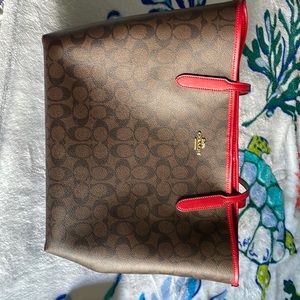 Brown and Red Coach tote an matching wallet.